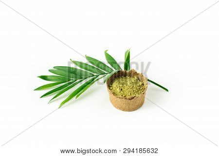 Henna Powder For Dyeing Hair And Eyebrows And Drawing Mehendi On Hands, Isolate With Green Palm Leaf