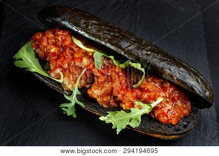 Black Hot Dog Bun With Minced Meat.