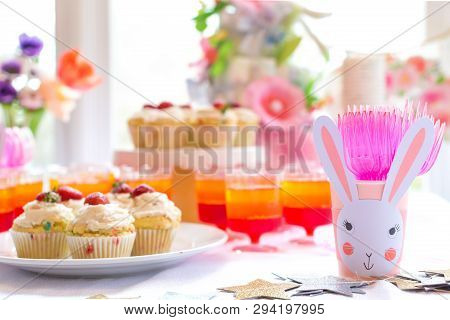 Dessert Table With Cupcakes And Flowers Easter Party Theme