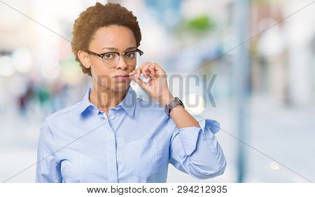 Young beautiful african american business woman over isolated background mouth and lips shut as zip with fingers. Secret and silent, taboo talking
