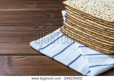 Stack Of Matzah Or Matza , Jewish Traditional Passover Celebration On A Wooden  Table With Copy Spac