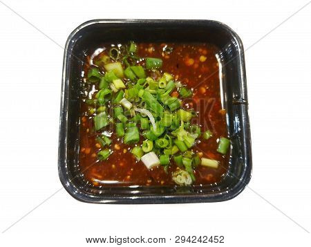 Thai Food Style, Top View Of Spicy Seafood Dipping Sauce Sprinkled With Scallion Sliced In Black Bow