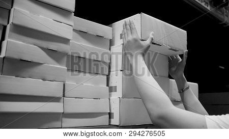 Warehouse Large Storage Or Cargo For Distribution And Man 's Hand Is Picking Up A Box.