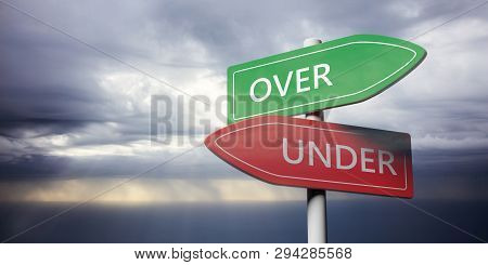 Betting Concept. Signpost With Opposite Directions Arrows, Over And Under Text, Against Dark Sky Bac