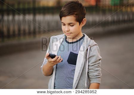Teenager Turn Off Smartphone. He Put Finger On Power Button