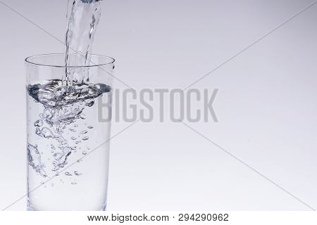 Filling Up The Water Glass From Water Filter Isolated Bright Background Copy Space