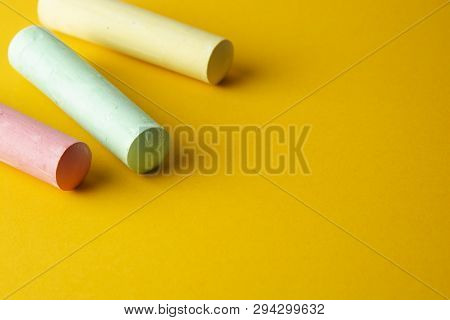 Education Template. Colorful Chalks Over Yellow Background With Copy Space. Childhod, Business And D