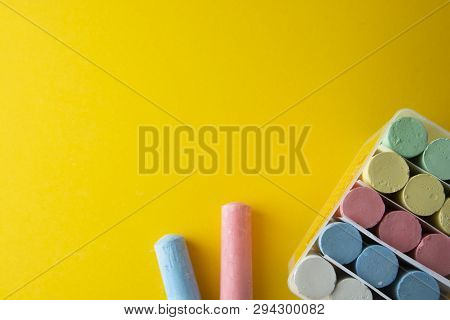 Abstract Colorful Chalks Over Yellow Background With Copy Space. Education Template. Creative Childh