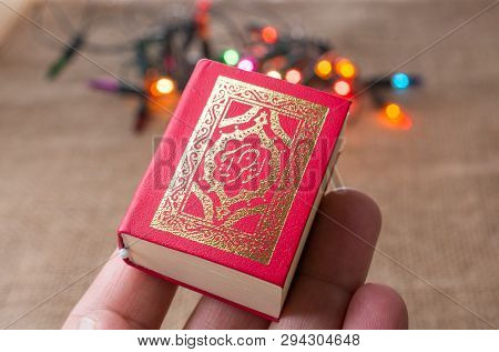 Islamic Holy Book Quran With Lights Behind