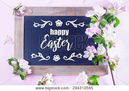 Spring Apple Tree Blooming Flowers On Pink Background, Top View Flat Lay Scene With Happy Easter Gre
