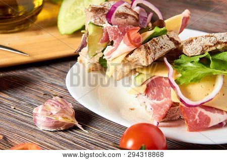 Sandwich With Bacon, Cheese, Garlic, Jalapeno Pepper And Herbs On A Plate, On A Wooden Background