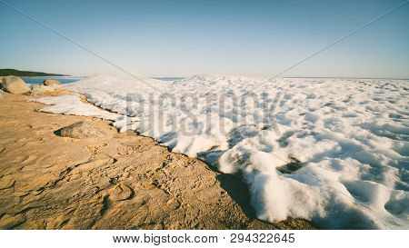 Snow Pile On The Beach, Hill. Large Snow Drift Isolated On A Blue Sky Background, 
Outdoor View Of I