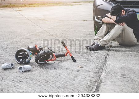 Image Of Shocked And Scared Driver After Accident Involved Kid's Bike And Helmet Lying On The Road O