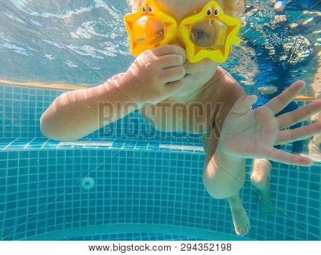 Little Girl Deftly Swim Underwater In Pool