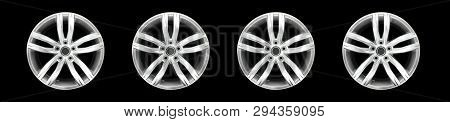 Front View On Set Of Steel Alloy Aluminium Car Rims. Isolated On Black Background.