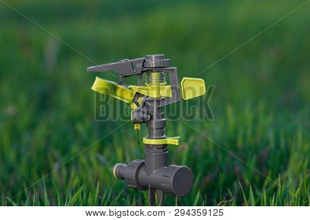 Irrigation Pulsating Sprinkler On Blurred Background. Selective Focus.