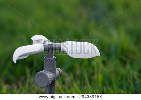 Modern Rotating Garden Sprinkler On A Spike. Sprinkler Isolated On A Green Grass Background. Waterin