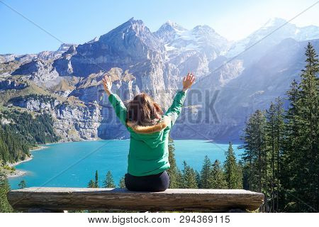 Happiness Asian Young Traveller Hiker Enjoys The Amazing View Of Oeschinensee Lake,wooden Chalet And