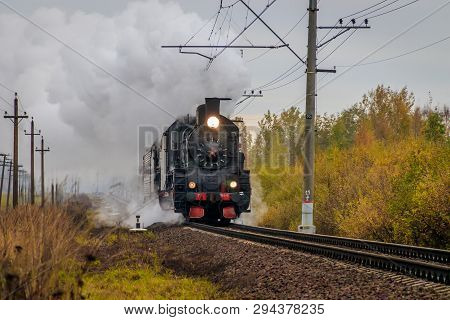 Old Russian Locomotive On The Railway. Old Black Locomotive. Smoke From The Engine. Russian Railway.