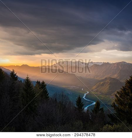 View From Border Road Of Italy And Slovenia Over Soca Valley With Village Kobarid To Mountain Range 
