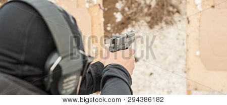 Shooting On Target In Shooting Range. Back Close-up Detail View