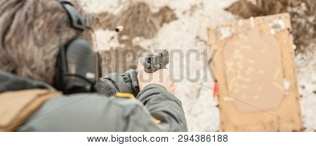 Shooting On Target In Shooting Range. Back Close-up Detail View