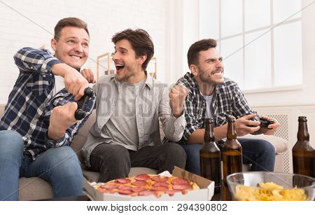 Avid Gamers. Excited Men Playing Video Games, Having Fun At Home