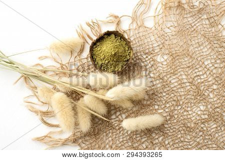 Henna Powder For Dyeing Hair And Eyebrows And Drawing Mehendi On Hands, Isolate With Green Palm Leaf