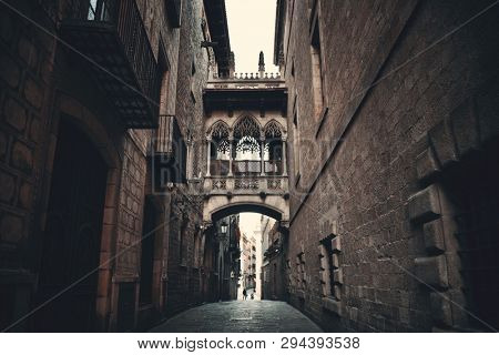 Pont del Bisbe and narrow street in Gothic Quarter in Barcelona Spain