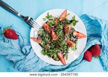 Healthy Organic Diet Salad With Arugula, Strawberries And Sesame With Balsamic Glaze In White Plate 