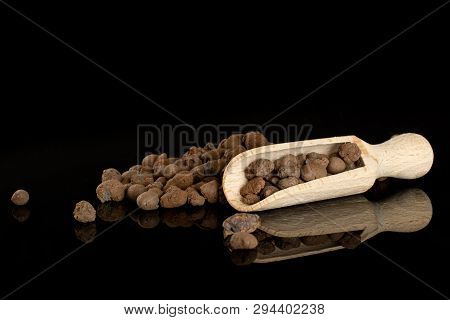 Lot Of Whole Brown Clay Pebbles (leca) With Wooden Scoop Isolated On Black Glass