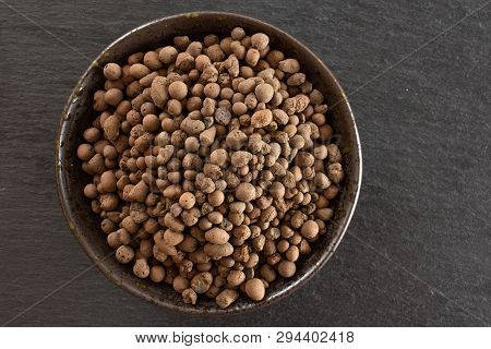 Lot Of Whole Brown Clay Pebbles (leca) On Grey Ceramic Plate Flatlay On Grey Stone
