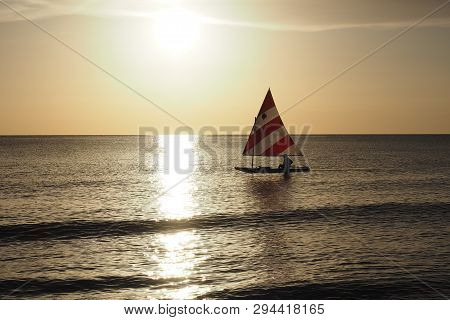 Captiva Island, Florida 08-05-2015 Active Senior Sails A Sunfish In Late Afternoon Light Off The Bea