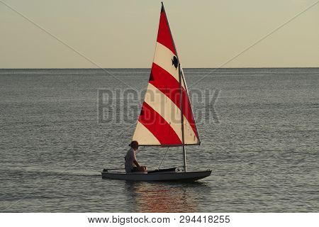 Captiva Island, Florida 08-05-2015 Active Senior Sails A Sunfish In Late Afternoon Light Off The Bea