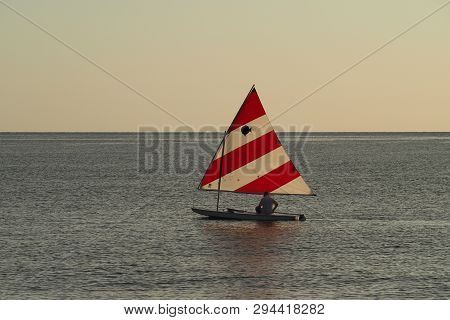 Captiva Island, Florida 08-05-2015 Active Senior Sails A Sunfish In Late Afternoon Light Off The Bea