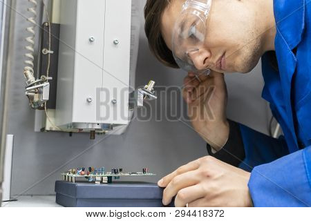 Scientist Wearing Blue Unifrom And Use X Ray Or Rontgen In Laboratory