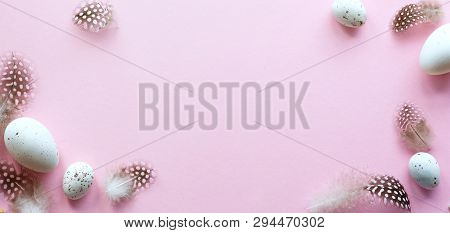 Easter Greeting Card With Easter Eggs And Sprin Flowers On Pink Table. Top View With Space For Your 