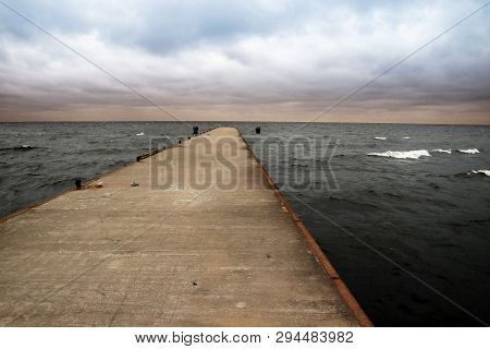 Pier Going Out Into The Bay Cape Flotski Under Stormy Skies.