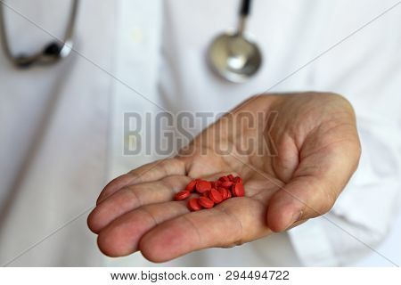 Red Pills In Palm Hand, Doctor Giving Medication In Tablets. Concept Of Pharmacist, Prescription, Me
