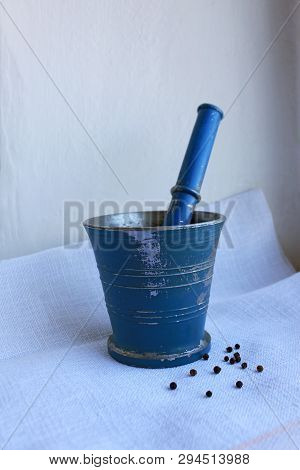 Black Peppercorns Ans Allspice In Ancient Metal Mortar With Pestle On Linen Background. Old Home Kit