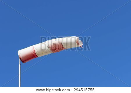 Red White Windsock Indicating From Where The Wind Comes With A Blue Background