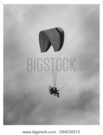 Flying On A Motor Paragliding. Tourist Being Guided On A Flight With A Powered Paragliding On A Clou