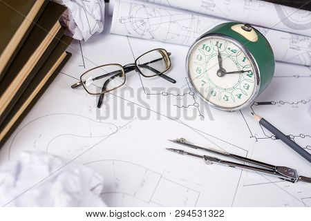 Several Drawings And Tools For Drawing On The Table In The Engineer
