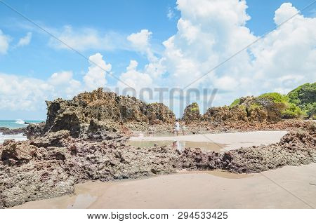 Conde - Pb, Brazil - February 22, 2019: Tourists At The Natural Pools Of The Beach Between Rock Form
