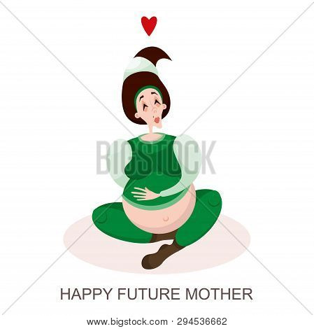 Happy Waiting For The Birth Of A Child. A Young Pregnant Brunette Woman Is Sitting In A Green Suit A