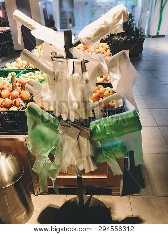 Stand With Many Single Use Plastic Bags In Supermarket At Vegetables. Ban Single Use Plastic. Rolls