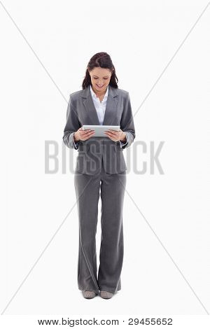 Businesswoman smiling watching a touch pad against white background