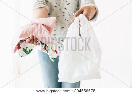 Ban Single Use Plastic. Zero Waste Shopping Concept. Woman Holding In One Hand Groceries In Reusable