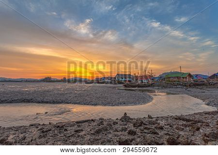 Stunning Sunset At Fishing Village In Phuket.during Low Tide Will Has A Small Canal Beside Fishing V