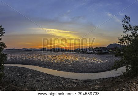 Stunning Sunset At Fishing Village In Phuket.during Low Tide Will Has A Small Canal Beside Fishing V